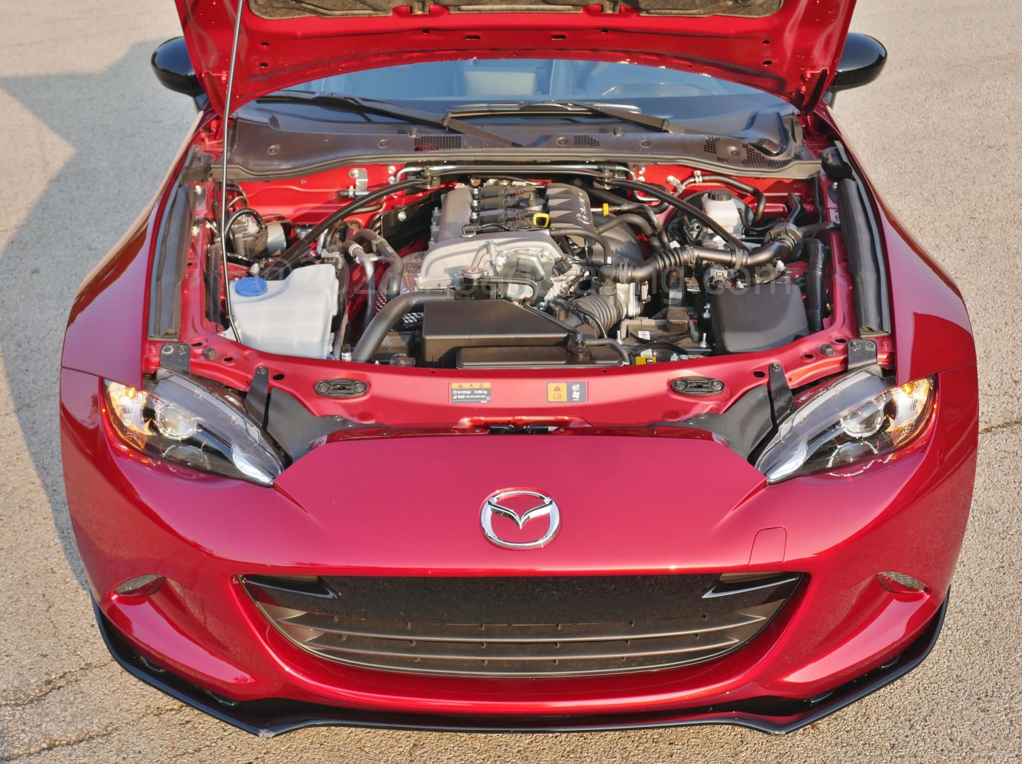 2023 Mazda MX-5 Miata RF Club: longitudinal 2.0L DOHC gas I-4 sends 181 hp & 155 lb-ft through close ratio 6 speed manual gearbox to rear propelling 2452 lbs briskly = 32 MPG