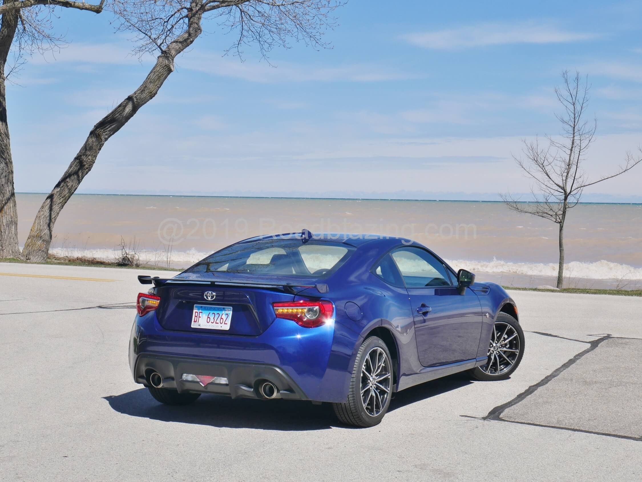 2019 Toyota 86 GT: Oceanic Blue watches stormy surf of Milwaukee's Lake Michigan shoreline, fitted with trunk-lid aero wing and amber LED rear directionals