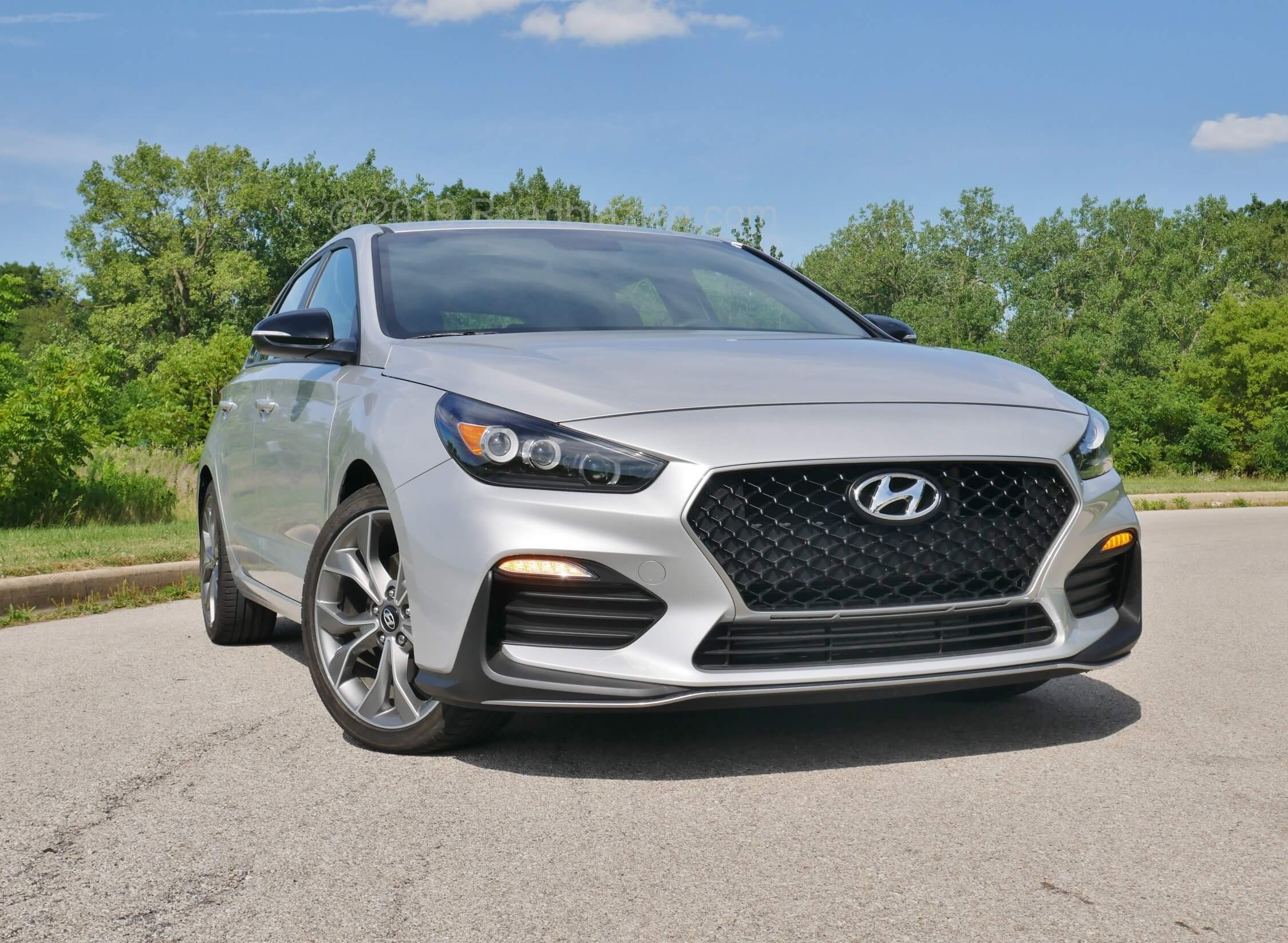 2019 Hyundai Elantra GT N-Line: Dark accenting permeates window frames, mirror caps, pouring molten chain link grille, straked lower front corner housings, and boomerang air dam corners.