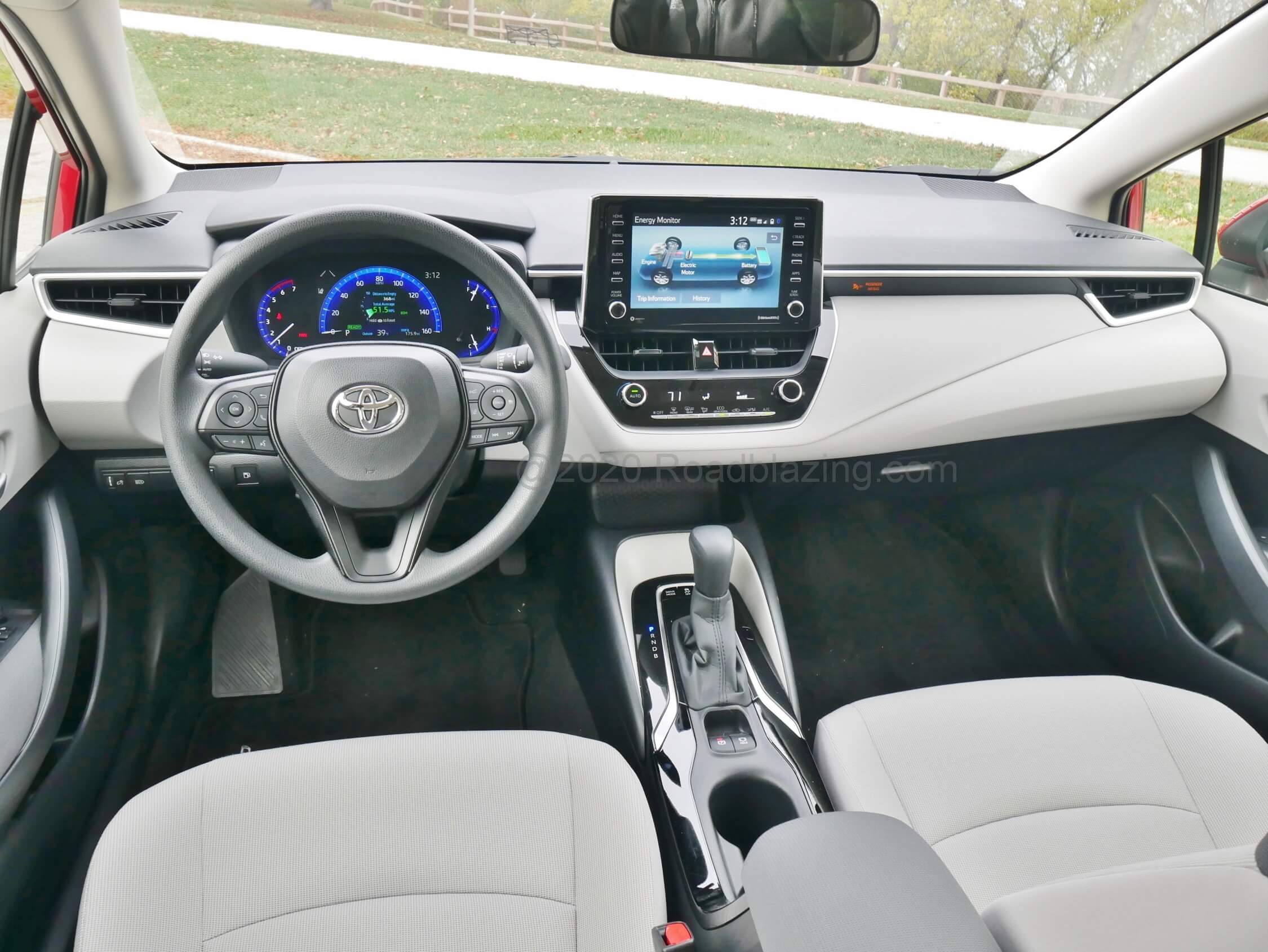 2021 Toyota Corolla Hybrid LE: airy, minimal fuss, large LED gauge cluster and 8.0" tablet mid center dashtop mount tri-pane touch LCD infotainment.