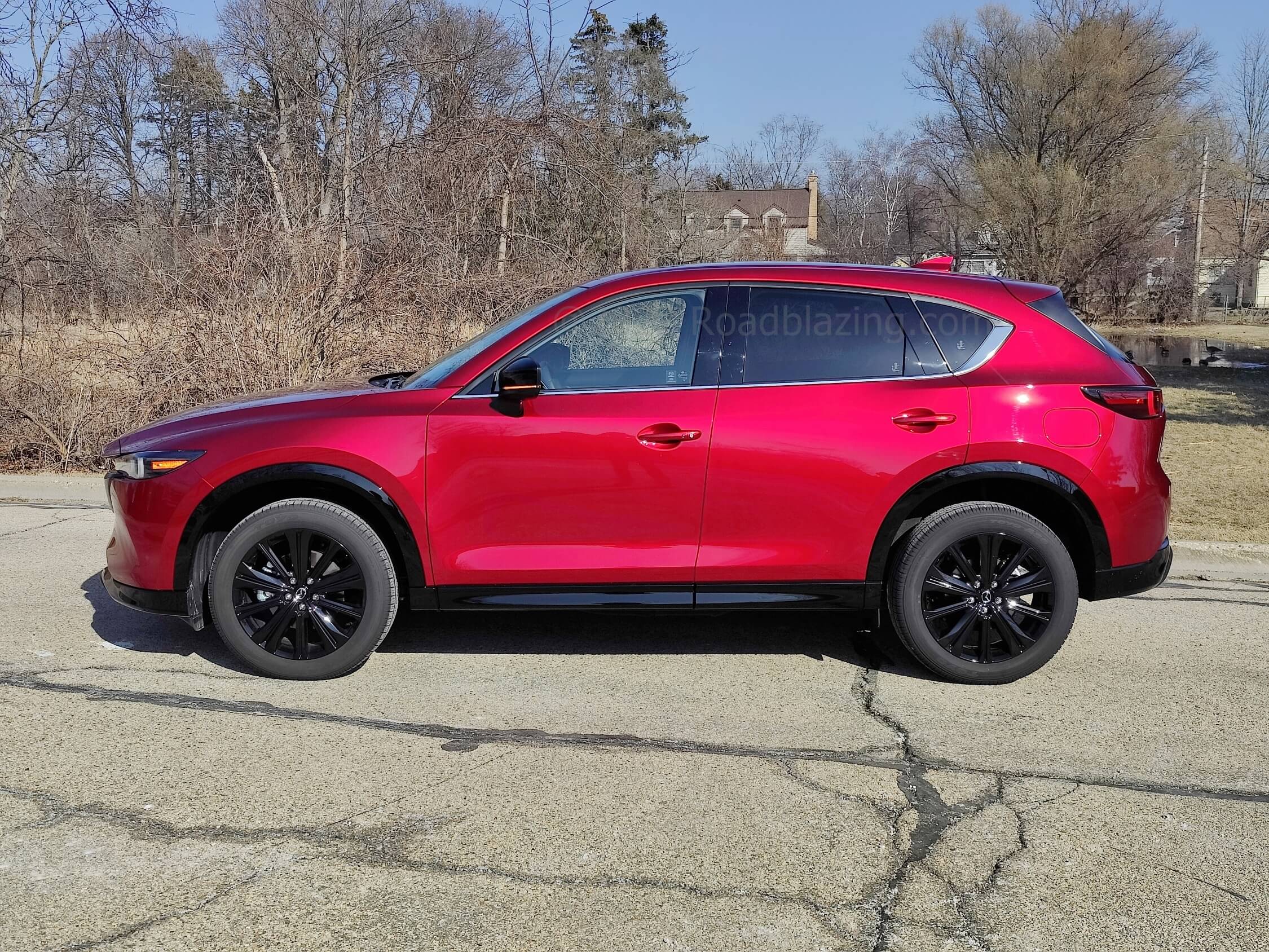 2022 Mazda CX-5 2.5T Turbo AWD: Soul Red Crystal Metallic hue contrasted by Turbo exclusive gloss black body cladding