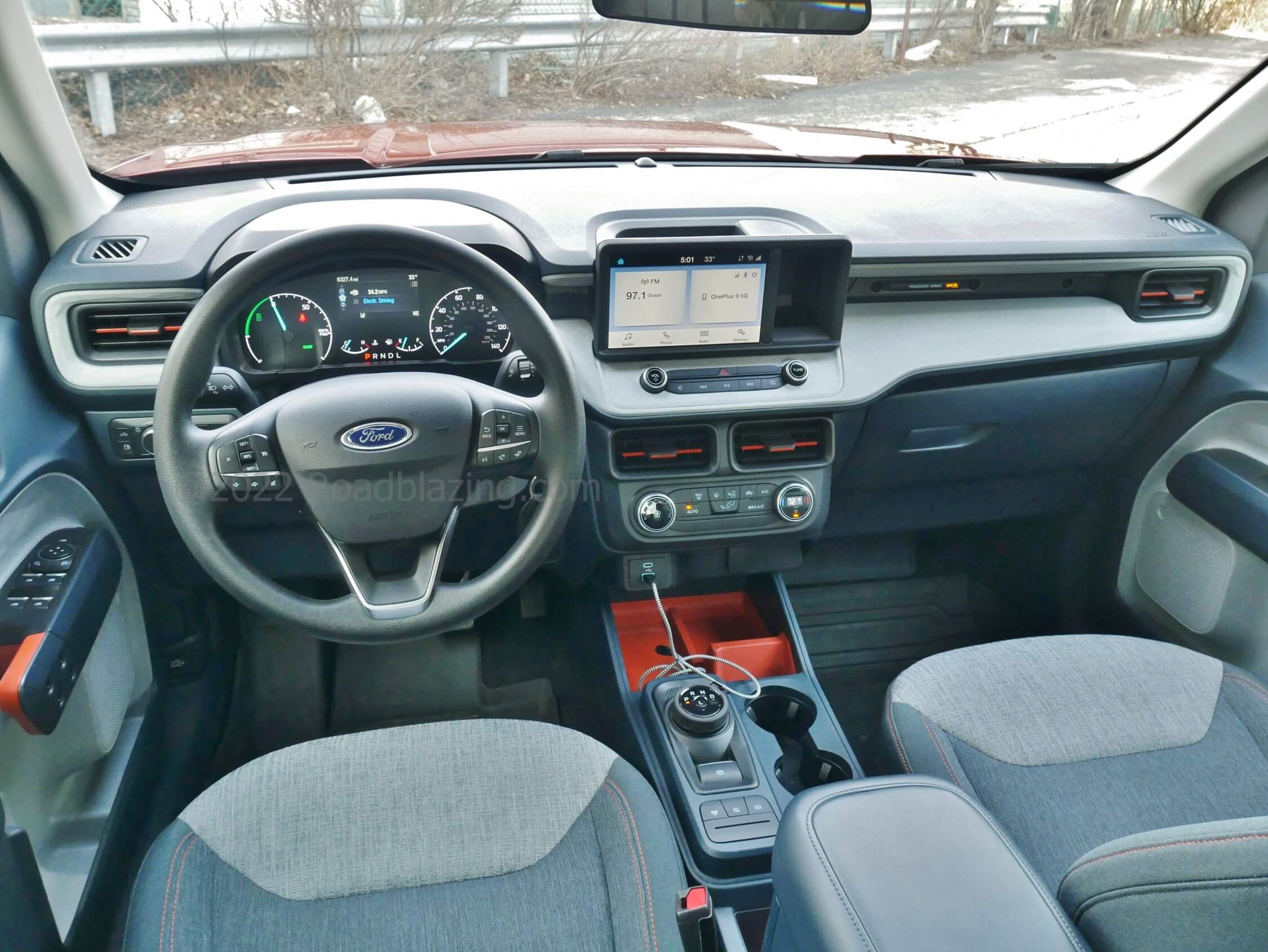 2022 Ford Maverick XLT 2.5L Hybrid: airy, roomy cockpit with levers and bins marked in orange, running the split pane Sync3 touch media display